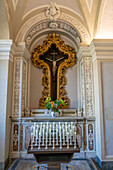 A metal sculpture of the crucifixion of Christ in the crypt of the Basilica of Sant'Antonino, Sorrento, Italy.