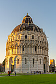 Baptistery of St. John of the Pisa Cathedral in the Piazza dei Miracoli in Pisa, Italy. The top half of the baptistery is Gothic style, while the lower half is Romanesque.