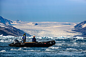 Tourists exploring the Kangerlussuaq Fjord in zodiac, Southeast coast, Greenland