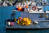 Colorful floats for fishing nets on a fishing boat in the harbor of Monterosso al Mare, Cinque Terre, Italy.