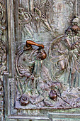 Detail of a main portal door of the Duomo of Pisa. Cast in bronze in 1605 by Giambologna. Pisa, Italy.