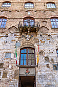 Facade of the 13th Century Palazzo Comunale, Palazzo del Popolo or city hall in San Gimignano, Italy.