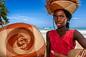 Woman seller of crafts, hats in the restaurant in front of the beach of plage de Ti Mouillage beach in Cayes-de-Jacmel, Cayes de Jacmel, Jacmel, Haiti.