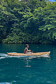 Residents of Vitu Islands in their traditional dugout canoes, Garove Island, Johann Albrecht Harbour, Papua New Guinea