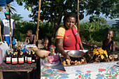 Food stall during Haiti Voodoo Festival in Saut d'Eau, in Saut d'Eau, Ville Bonheur, Haiti. Thousands of both Vodou and Catholic followers gathered under the Saut d'Eau waterfall in Haiti. The pilgrimage, made by Voodou practitioners and Catholics alike, originated with the sighting of the likeness of the Virgin Mary on a palm leaf close to the falls half a century ago. Catholism and Voodou practices are forever intertwined in its Haitian form. The appearance of a rainbow beneath the falls is said indicate that Danbala - the great lord of the waterfall - and Ayida Wedo - the rainbow - are maki