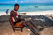 Fisherman fixing the nets in Cayes-à-L’eau, a fishermen islet located northeast of Caye Grand Gosie, Île-à-Vache, Sud Province, Haiti