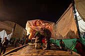 In the workshop, just a few hours before the parade, artisans fine-tune the last details and carry out the final assembly of their floats and individual costumes, preparing these magnificent works for the Great Parade of the Black and White Carnival. Pasto, Nariño, Colombia. January 5, 2025.