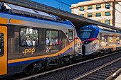 Two Trenitalia Pop passenger trains nose to nose at the station in Levanto, Italy. The Pop is a Coradia Stream built by Alstom.