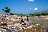 Cleaning clothes on banks of Riviere de la Cosse, Jacmel, Haiti