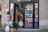 Poor and vulnerable families collecting donated products in the supermarket Rebost Solidari de Gracia, Gracia neighborhood, Barcelona, Spain, Europe. The Rebost Solidari de Gracia is a distributor entity of the Food Bank in its Sec, SERMA (fresh fruit and vegetables), cold chain (frozen and refrigerated products) and FEGA (products received from the EU) programs. An efficient management of all the food surpluses generated by the neighborhood (markets, supermarkets, shops, companies, restaurants, school canteens and others) is an important enough objective in itself, both for its use in the nei