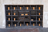 Wine bottle corks arranged on a ventilation grate on the portico of the Hospital of the Innocents, Florence, Italy.