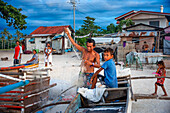 Local fishers in white sand beach in of Langub Beach Malapascua island, Cebu, Philippines