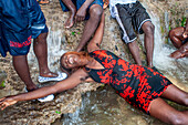 Haiti Voodoo Festival in Saut d'Eau, in Saut d'Eau, Ville Bonheur, Haiti. Thousands of both Vodou and Catholic followers gathered under the Saut d'Eau waterfall in Haiti. The pilgrimage, made by Voodou practitioners and Catholics alike, originated with the sighting of the likeness of the Virgin Mary on a palm leaf close to the falls half a century ago. Catholism and Voodou practices are forever intertwined in its Haitian form. The appearance of a rainbow beneath the falls is said indicate that Danbala - the great lord of the waterfall - and Ayida Wedo - the rainbow - are making love. Fertility