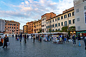 Tourists and vendors selling artwork and souvenirs in the Piazza Navona in Rome, Italy.