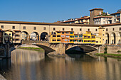 The Ponte Vecchio, a medieval stone arch bridge over the Arno in Florence, Italy.