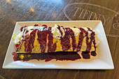 A sweet crepe topped with whipped cream, blueberry and lemon sauce.