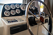 Steering wheel and controls to pilot inside a boat for a rent in the Canal of Midi trip on the river, France, Europe