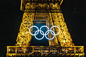 Olympic rings on Eiffel Tower at night, Paris, France