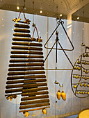 A collection of antique percussion instruments in the Accademia Gallery in Florence, Italy. Includes triangles, castanets, jingles and xylophones.