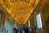 Tourists in the Gallery of Maps in the Vatican Museums, Vatican City, Rome, Italy.