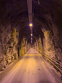 Driving through a tunnel through the marble quarry mountain after a quarry tour at Carrara, Italy.