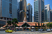 High rise apartments and office skyscrapers towering over Lau Pa Sat food market on Raffles Quay downtown Singapore