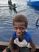 Residents of New Hanover island in their traditional dugout canoes, New Ireland province, Papua New Guinea