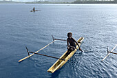 Residents of Tungelo Island in their traditional dugout canoes, New Ireland province, Papua New Guinea