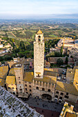 Torre Rognosa or Rognosa Tower on Piazza del Duomo in the medieval walled town of San Gimignano, Italy. At left is the shorter Torre Chigi.