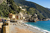 Tourists on the beach in off peak season at Monterosso al Mare, Cinque Terre, Italy.