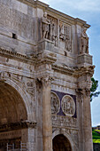 Detail of the Arch of Constantine, a triumphal arch in the Colosseum Archeological Park in Rome, Italy.