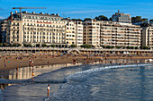 Landscape view over Playa de La Concha beach in San Sebastian, Gipuzkoa, Donostia San Sebastian city, north of Spain, Euskadi, Euskaerria, Spain. Hotel Londres (London) first building on right overlooking beach.