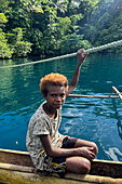 Residents of Vitu Islands in their traditional dugout canoes, Garove Island, Johann Albrecht Harbour, Papua New Guinea