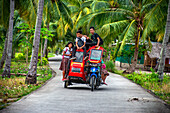 Local students, fanny many people driving a motorcyce in Sipaway Island, San Carlos City, Negros Occidental, Philippines