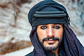 Portrait of a bedouin souvenirs seller at The Treasury, Al Khazneh, at night, Petra, Jordan.