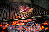 Spanish beef Chuleton, also known as Bone-in Ribeye steak, Cowboy steak, Prime Rib steak or Veal chop, on the charcoal in Sidreria Urbitarte Sagardotegia in Ataun Goierri, Basque Highlands Basque Country, Gipuzkoa, Euskadi Spain.