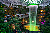 Jewel Changi Airport is a new terminal building under a glass dome, with indoor waterfall and tropical forest, shopping malls and dining, in Singapore