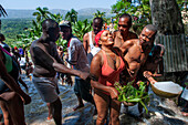 Haiti Voodoo Festival in Saut d'Eau, in Saut d'Eau, Ville Bonheur, Haiti. Thousands of both Vodou and Catholic followers gathered under the Saut d'Eau waterfall in Haiti. The pilgrimage, made by Voodou practitioners and Catholics alike, originated with the sighting of the likeness of the Virgin Mary on a palm leaf close to the falls half a century ago. Catholism and Voodou practices are forever intertwined in its Haitian form. The appearance of a rainbow beneath the falls is said indicate that Danbala - the great lord of the waterfall - and Ayida Wedo - the rainbow - are making love. Fertility