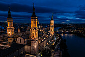 Aerial view of the Cathedral Basilica of Our Lady of the Pillar illuminated at night during Christmas, Zaragoza, Spain