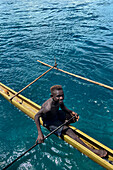 Residents of Tungelo Island in their traditional dugout canoes, New Ireland province, Papua New Guinea