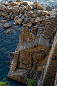 Steep stairway down to a mooring rope by the water of the Lingurian Sea by Riomaggiore, Cinque Terre, Italy.