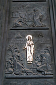 Detail of the bronze door of the main portal of the Basilica of St. Paul Outside the Walls, Rome, Italy.