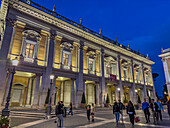 Tourists in the Piazza del Campidoglio or Capitoline Square with the Palazzo Nuovo behind. Rome, Italy.