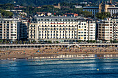 Landscape view over Playa de La Concha beach in San Sebastian, Gipuzkoa, Donostia San Sebastian city, north of Spain, Euskadi, Euskaerria, Spain. Hotel Londres (London) first building on right overlooking beach.