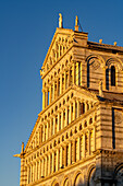 The west facade of the Pisa Duomo or Primatial Metropolitan Cathedral of the Assumption of Mary in Pisa, Italy.