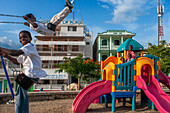 Chindren playing in the children's playground in Jacmel town square in Jacmel city center, Haiti