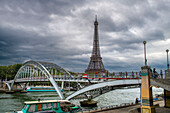 Passenger touristic cruise ship in the Seine river is moored to the pier near Eiffel Tower