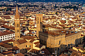 View of the towers of the Badia Fiorentina & Palazzo del Bargello seen from the Palazzo Vecchio tower in Florence, Italy. The shadow of the Palazzo Vecchio tower is projected onto the Palazzo del Bargello.