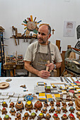 Master craftsman Antonino Guarracino working on wood inlays and laminate jewelry in Sorrento, Italy.