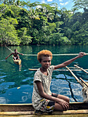 Residents of Vitu Islands in their traditional dugout canoes, Garove Island, Johann Albrecht Harbour, Papua New Guinea